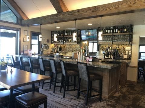 Renovated bar grille with timber ceiling beams at Perry Park Country Club